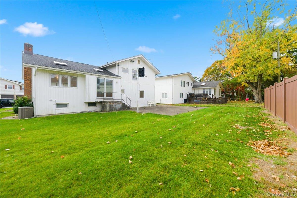 930 Jewel Drive Valley Stream, NY 11581 - Photo 28 of 32 a view of a white house with a big yard and large trees