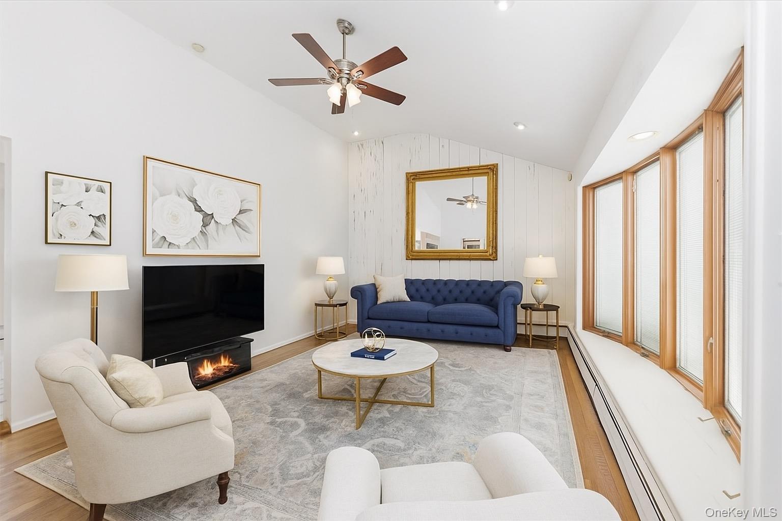 930 Jewel Drive Valley Stream, NY 11581 - Photo 3 of 32 a living room with furniture a flat screen tv and a large window