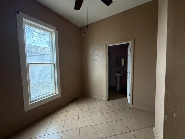 an empty room with closet and windows