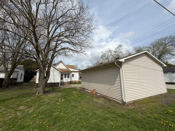 a view of a white house with a yard