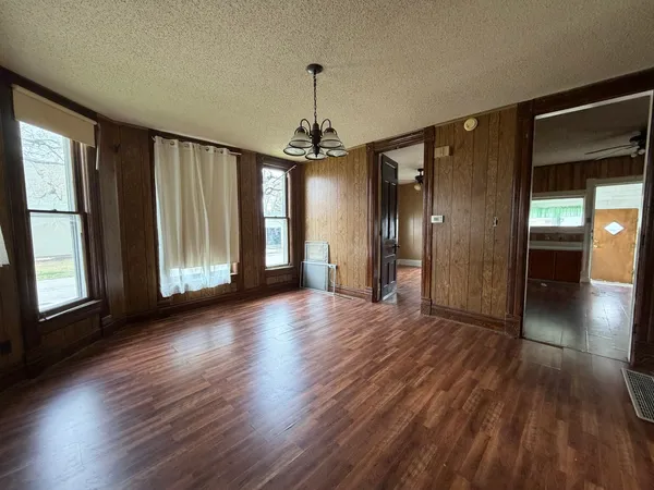 a view of a room with wooden floor and windows