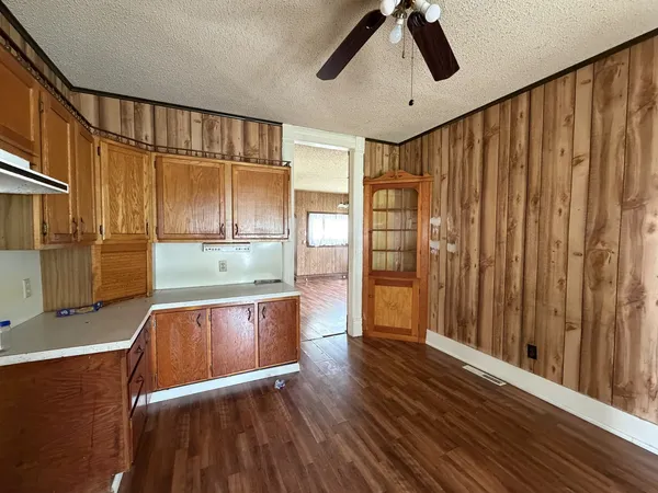 a open kitchen with wooden floor and window