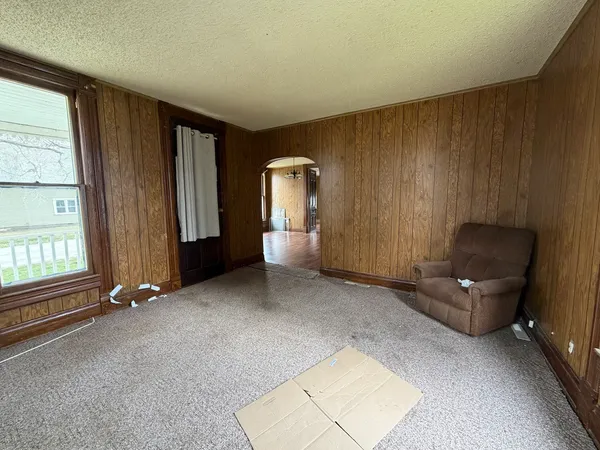an empty room with windows and closet
