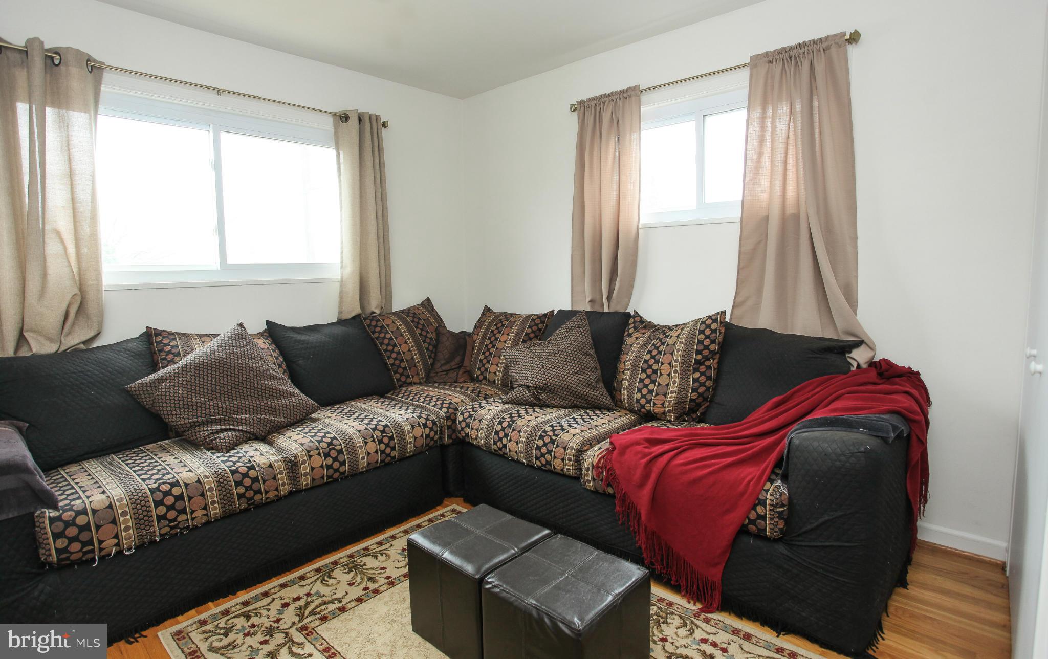 938 Vanderwood Road Baltimore, MD 21228 - Photo 15 of 26 a living room with a couch and a large window