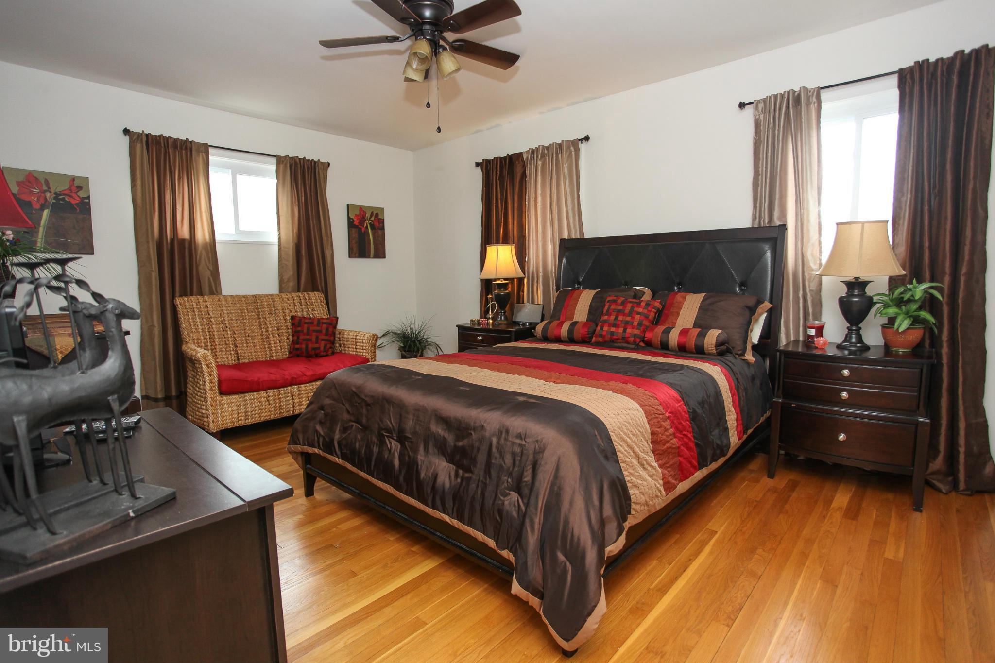 938 Vanderwood Road Baltimore, MD 21228 - Photo 18 of 26 a bedroom with a bed and a chandelier