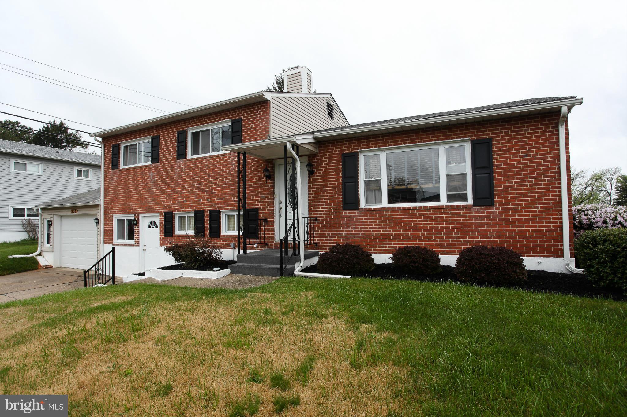938 Vanderwood Road Baltimore, MD 21228 - Photo 26 of 26 a front view of a house with a garden and yard