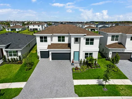 an aerial view of a house with a yard