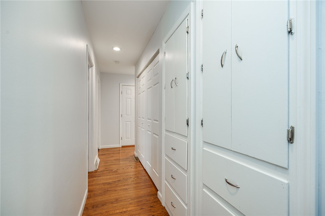 6950 Red Lion 5 Points Road Springboro, OH 45066 - Photo 36 of 78 Bright hallway with built-in storage and sleek hardwood flooring.