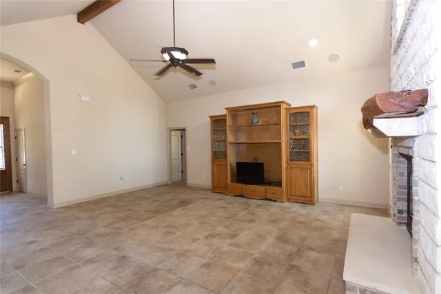 a view of empty room with a fireplace