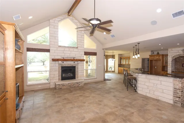 a view of an empty room with a fireplace and a window