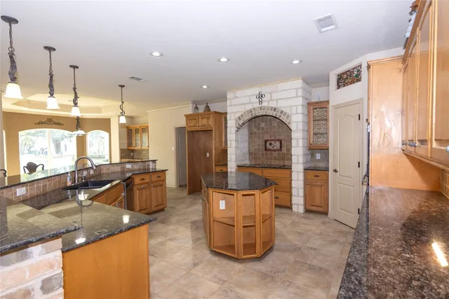 a living room with furniture a large window and a chandelier