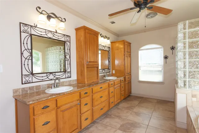 a bathroom with a double vanity sink mirror and a bathtub
