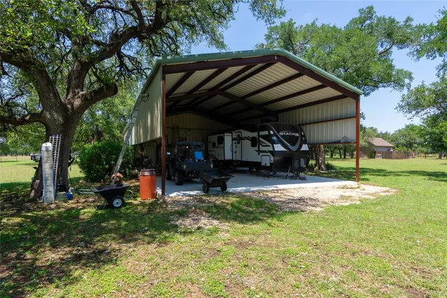 a view of a house with backyard and sitting area