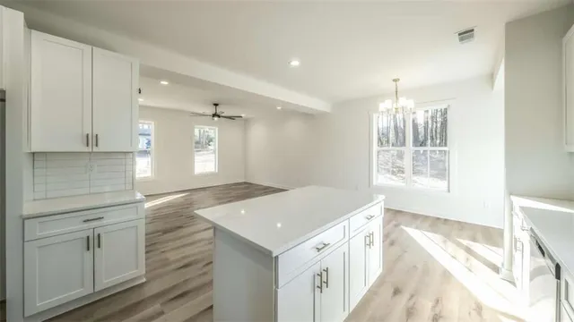 a kitchen with a stove and white cabinets