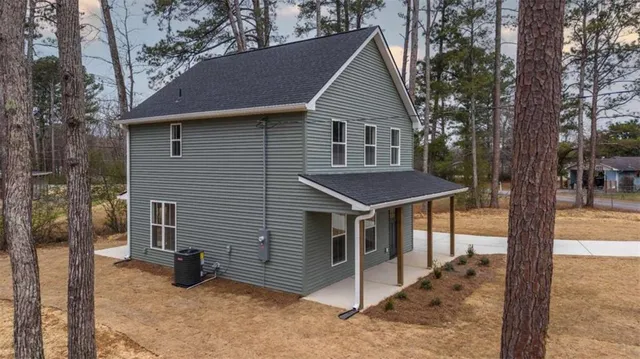a view of a house with a yard and tree