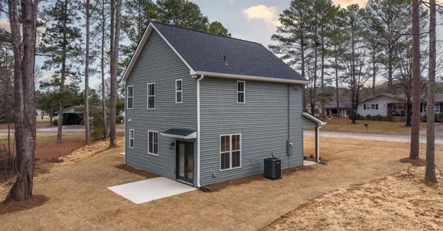 a view of a house with a yard covered in snow