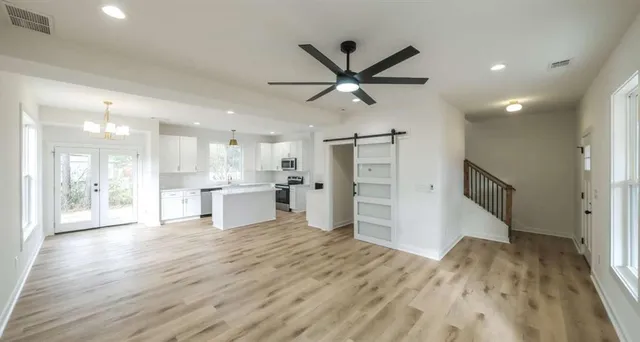 a view of a kitchen with a sink and a refrigerator