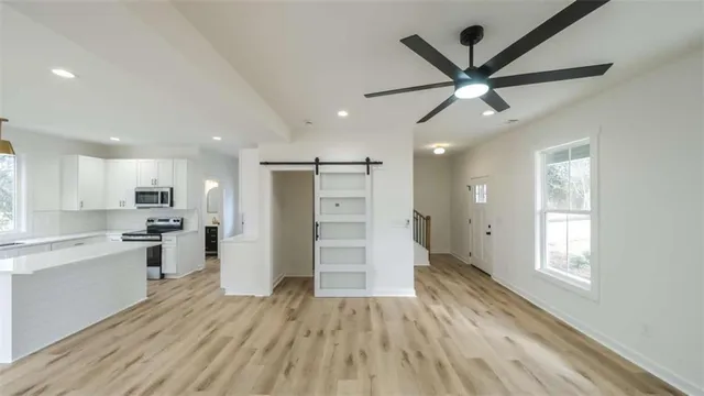 a view of a kitchen with a sink and a window