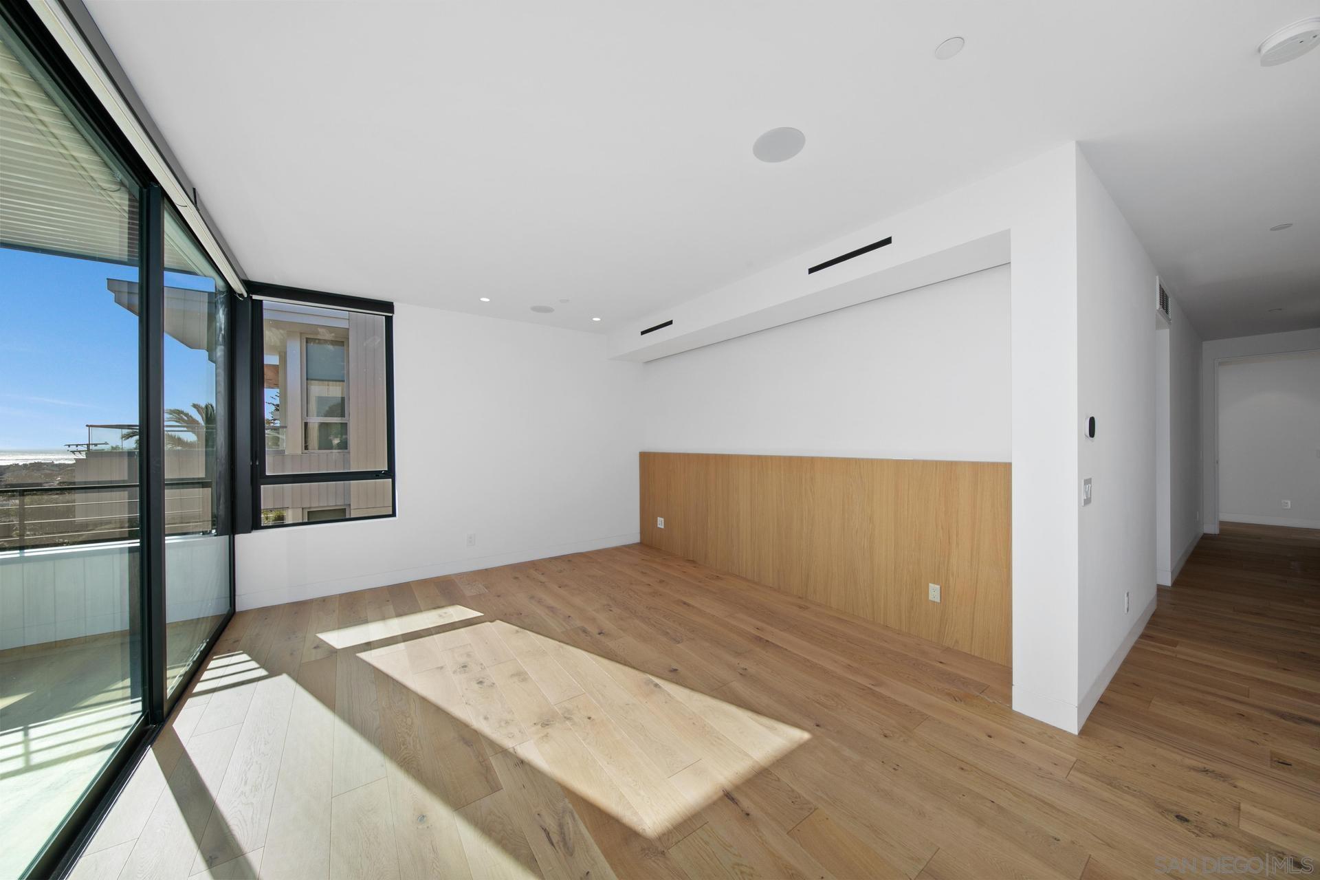 664 Cornish Drive Encinitas, CA 92024 - Photo 11 of 46 a view of a big room with wooden floor and windows