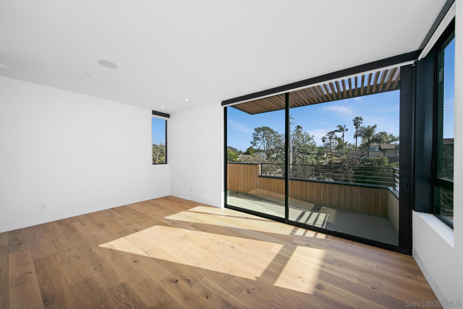 664 Cornish Drive Encinitas, CA 92024 - Photo 12 of 46 a view of a big room with wooden floor and windows