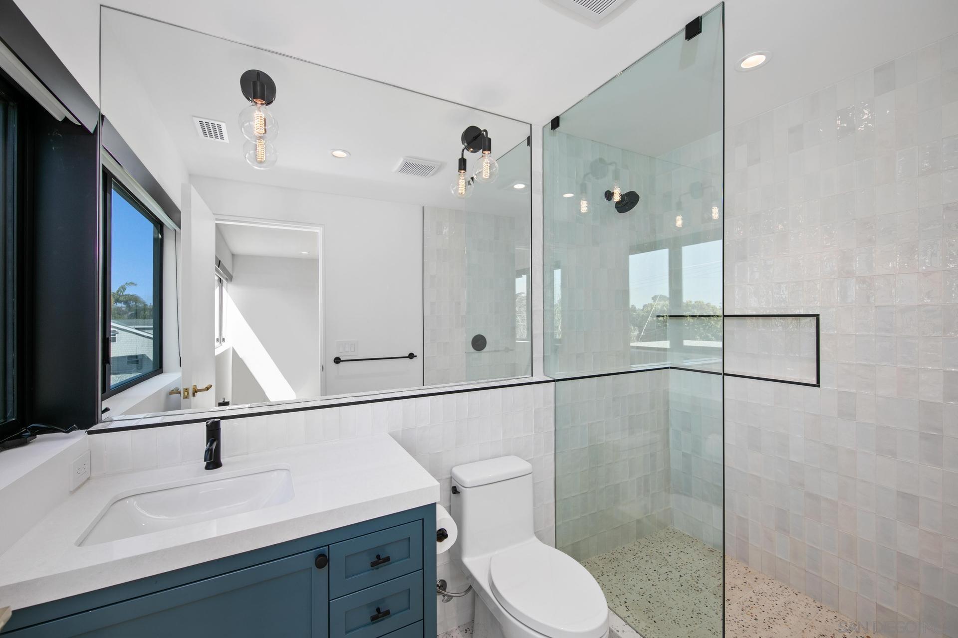 664 Cornish Drive Encinitas, CA 92024 - Photo 23 of 46 a bathroom with a sink a toilet and shower