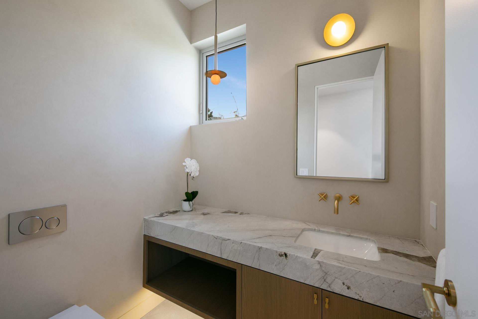 664 Cornish Drive Encinitas, CA 92024 - Photo 24 of 46 a bathroom with a sink and a mirror