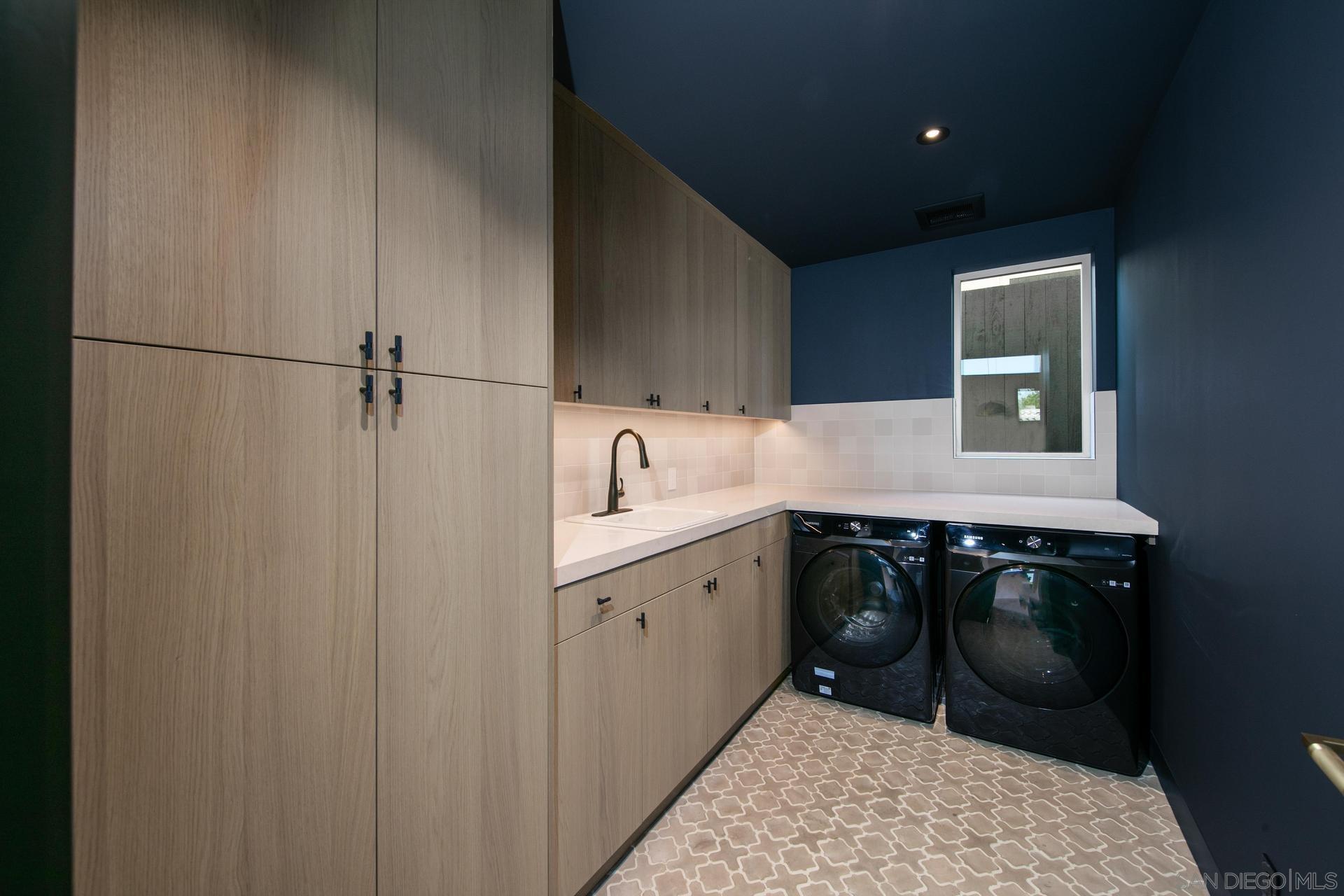 664 Cornish Drive Encinitas, CA 92024 - Photo 25 of 46 a utility room with a sink a washer and dryer