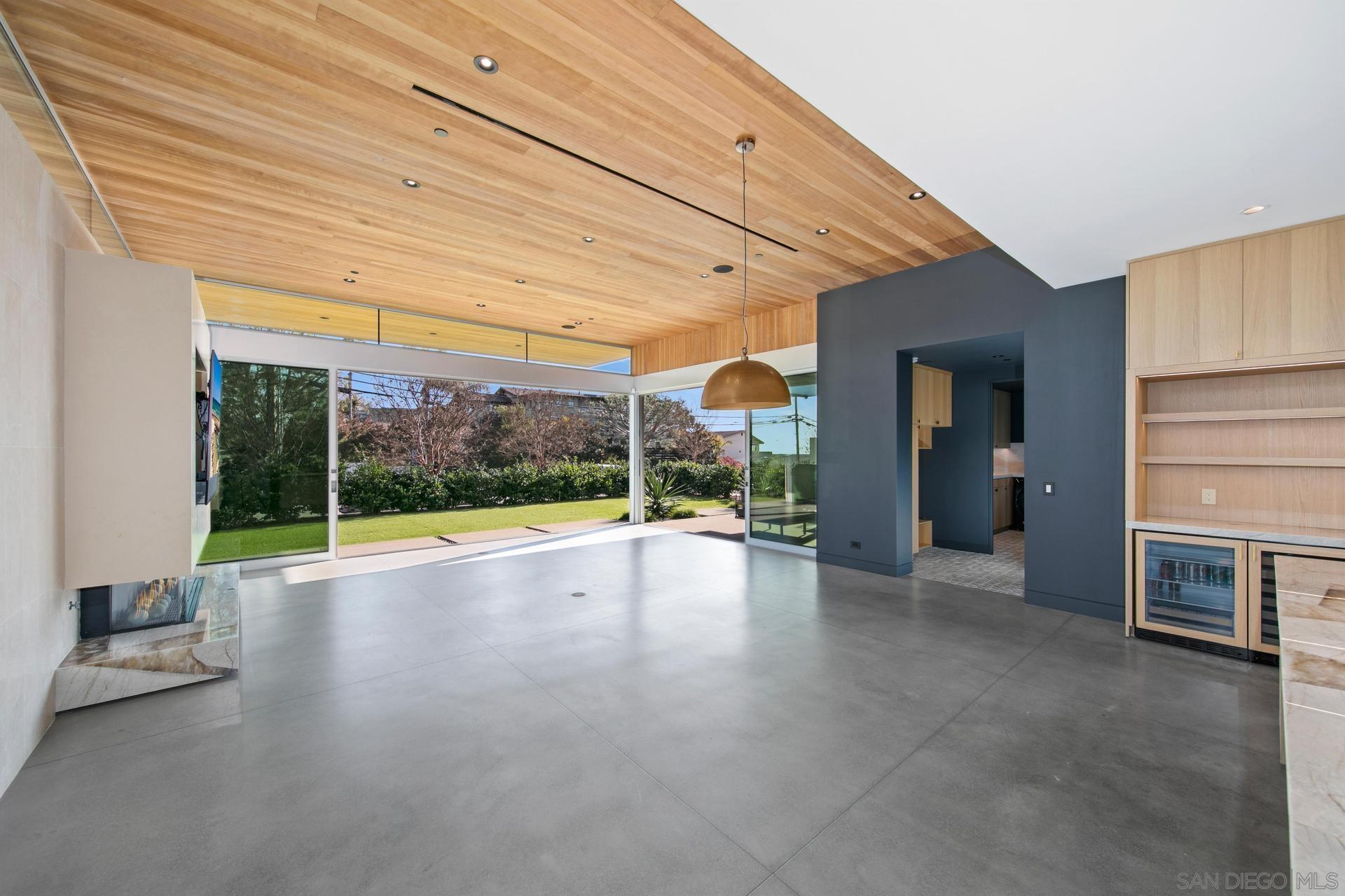 664 Cornish Drive Encinitas, CA 92024 - Photo 6 of 46 a view of a patio with table and chairs and floor to ceiling window
