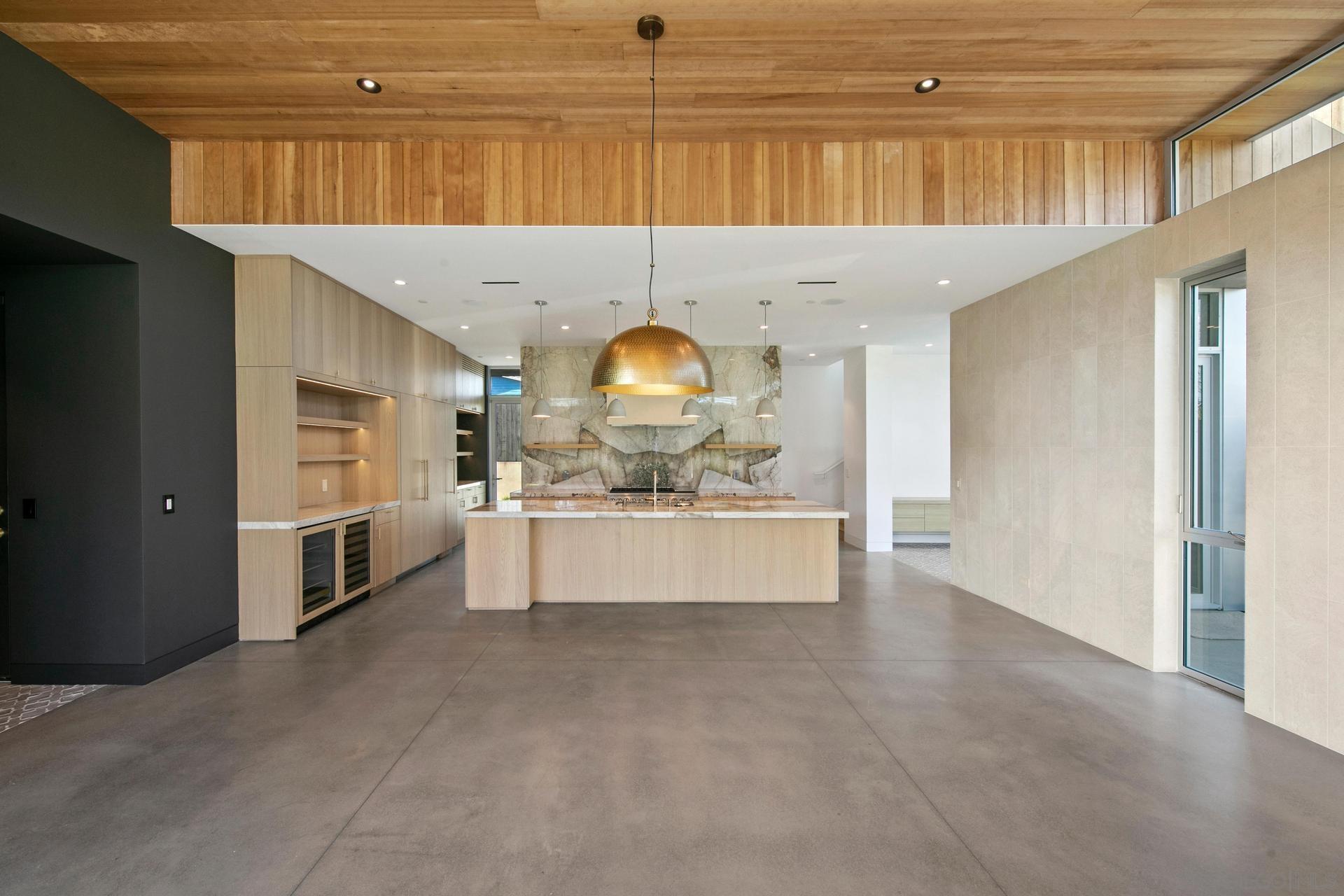 664 Cornish Drive Encinitas, CA 92024 - Photo 7 of 46 a large kitchen with stainless steel appliances a large counter top a stove and a refrigerator