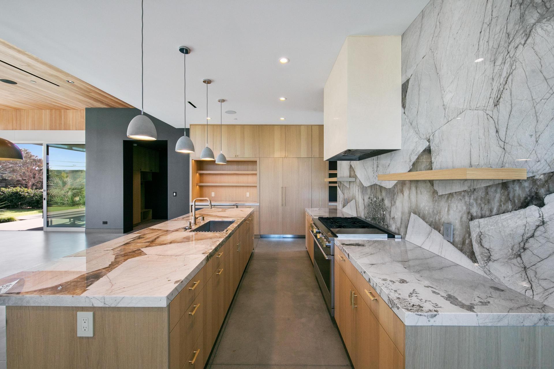 664 Cornish Drive Encinitas, CA 92024 - Photo 9 of 46 a large kitchen with stainless steel appliances kitchen island granite countertop a large counter top a stove and a refrigerator