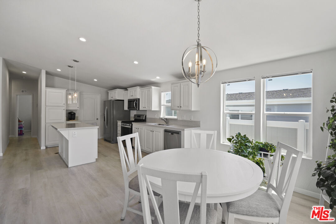 30473 Mulholland Highway, Unit 174 Agoura Hills, CA 91301 - Photo 15 of 36 a large kitchen with a table and chairs