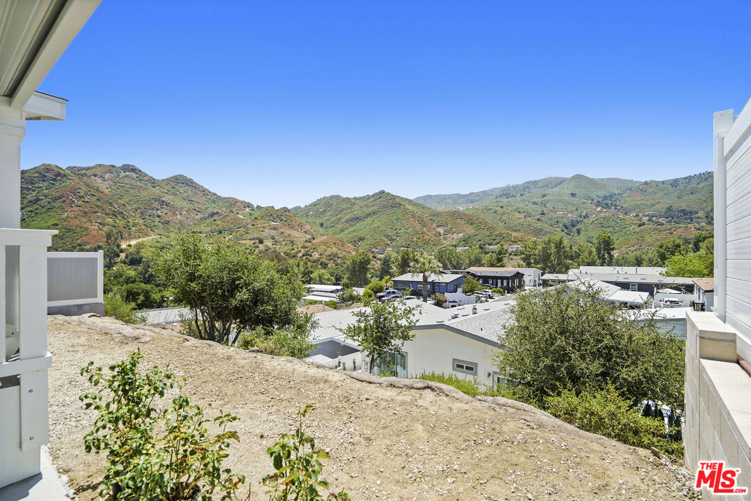 30473 Mulholland Highway, Unit 174 Agoura Hills, CA 91301 - Photo 24 of 36 a view of a terrace with a garden and mountain view