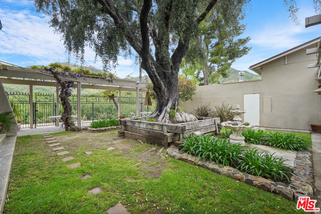 30473 Mulholland Highway, Unit 174 Agoura Hills, CA 91301 - Photo 34 of 36 a house view with a sitting space and garden view
