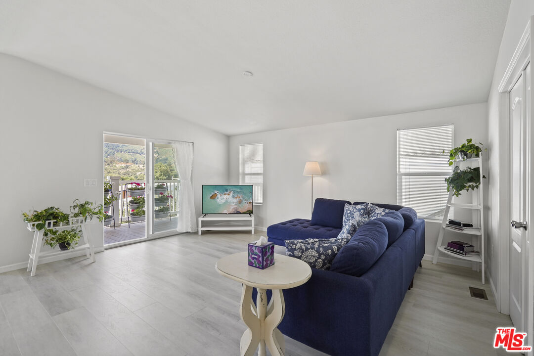 30473 Mulholland Highway, Unit 174 Agoura Hills, CA 91301 - Photo 10 of 36 a living room with furniture and a table