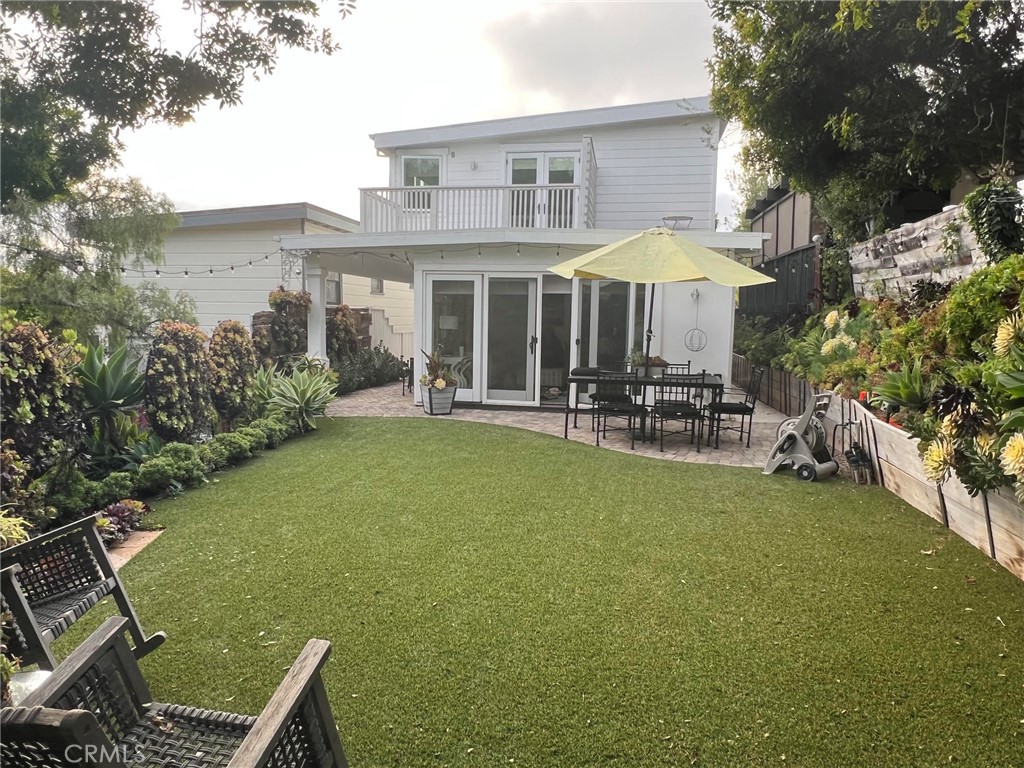 263 Upland Road Laguna Beach, CA 92651 - Photo 10 of 56 a backyard of a house with yard and outdoor seating