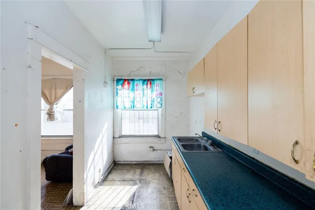 a kitchen with a refrigerator and a sink