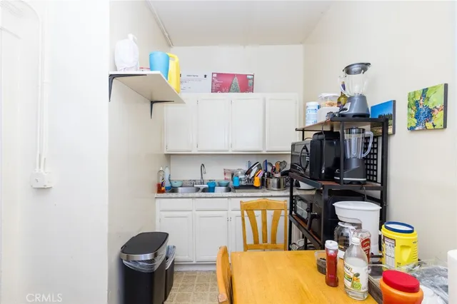 a bed room with a bed a couch and a chandelier