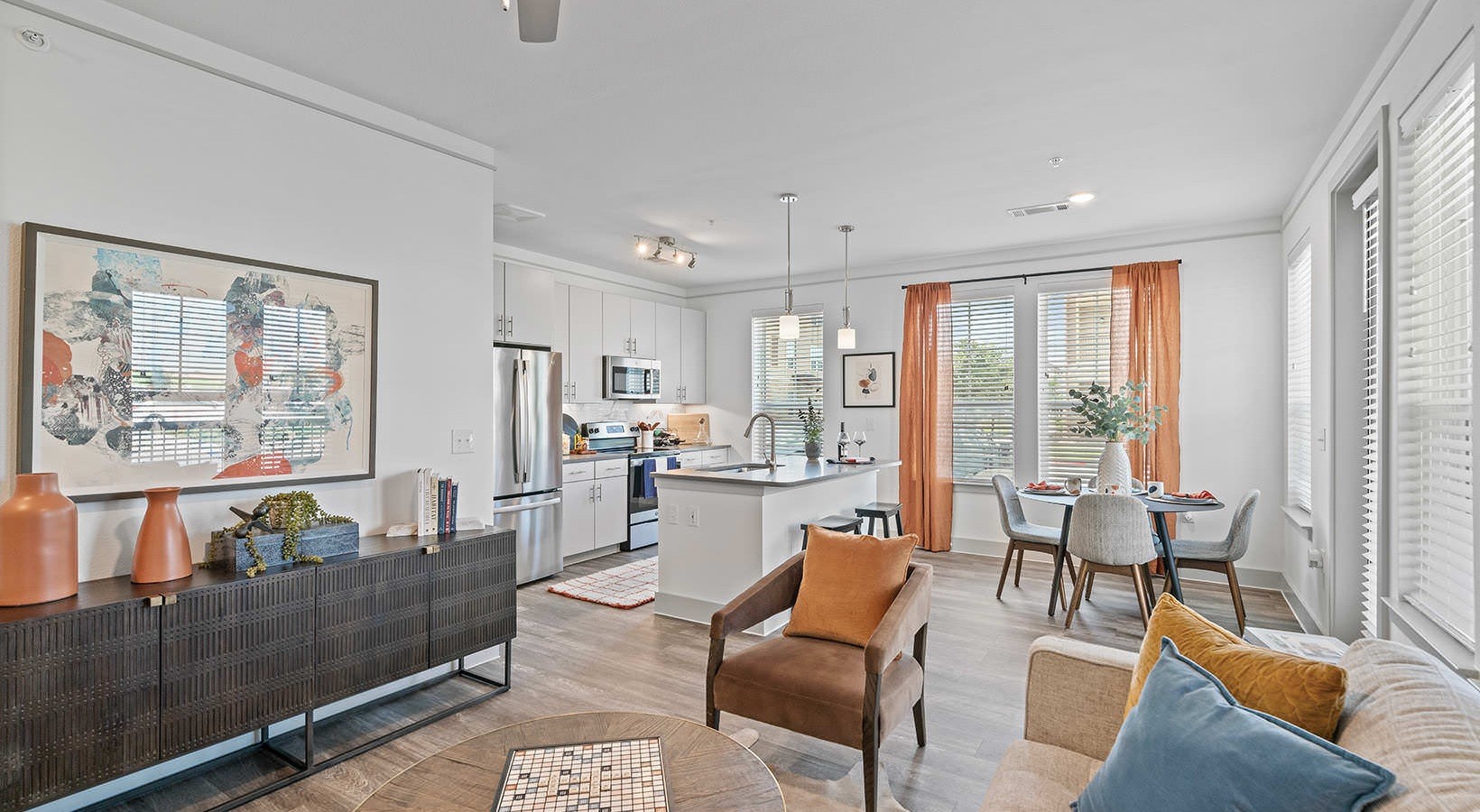 a living room with furniture and large windows