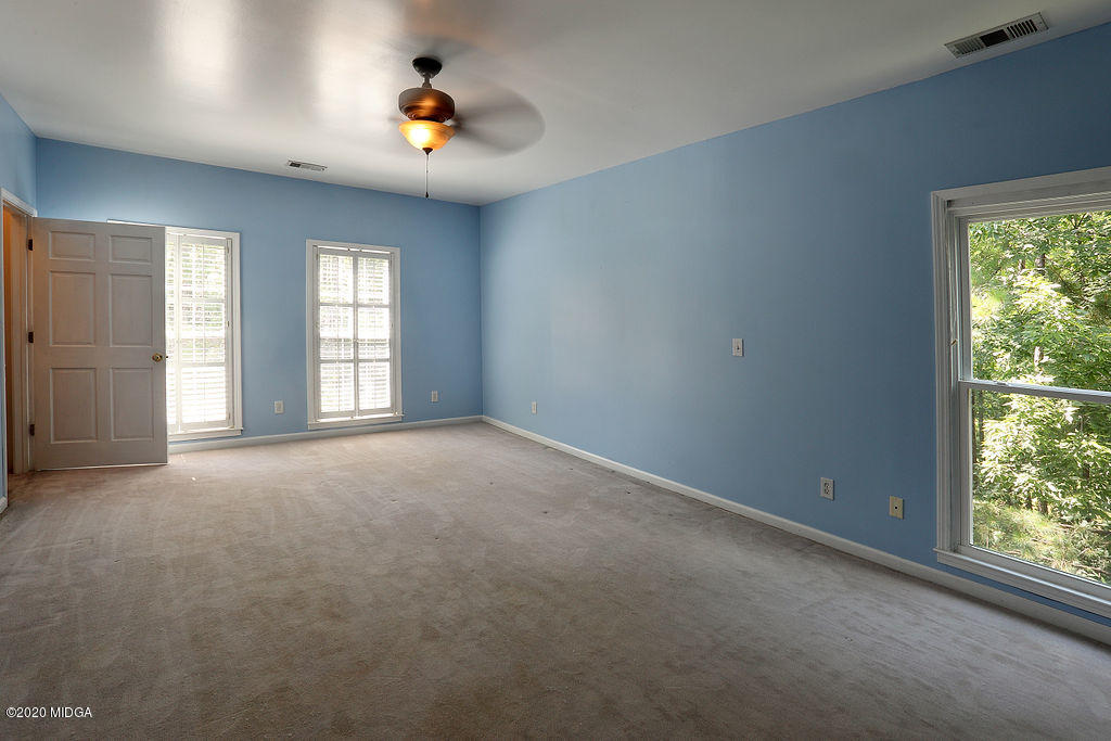 411 Lamar Road Macon, GA 31220 - Photo 7 of 22 an empty room with windows and ceiling fan
