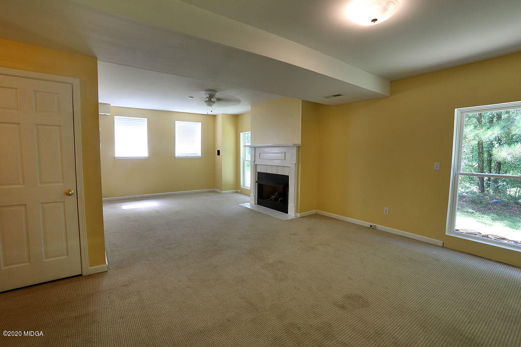 411 Lamar Road Macon, GA 31220 - Photo 10 of 22 an empty room with windows and fireplace
