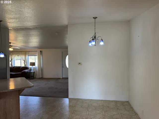 a kitchen with stainless steel appliances a sink a stove a refrigerator cabinets and a window