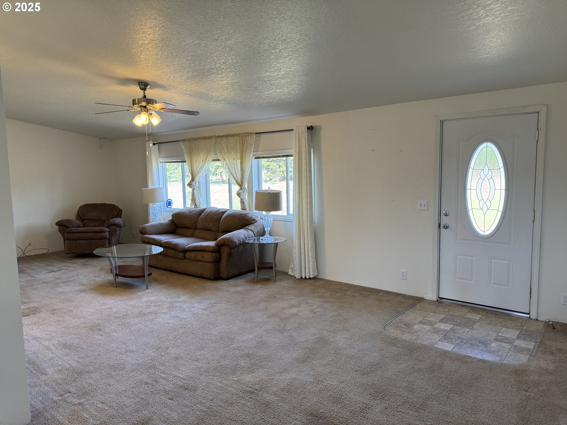 1924 Highway 97 Goldendale, WA 98620 - Photo 17 of 40 a living room with furniture a ceiling fan and a window