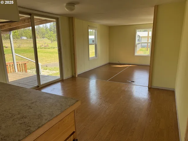 a view of a livingroom with a kitchen and a sink