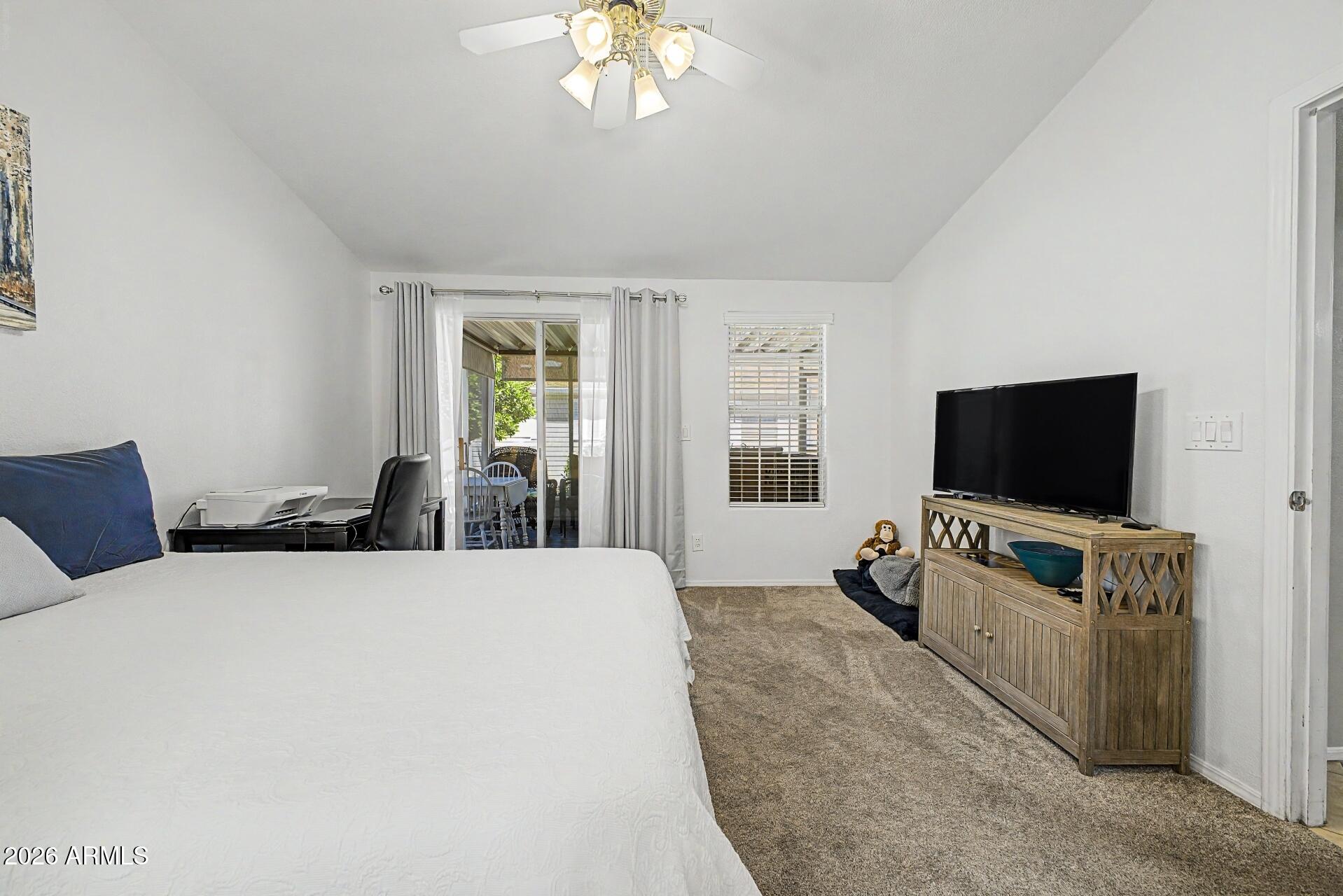 2550 South Ellsworth Road, Unit 46 Mesa, AZ 85209 - Photo 14 of 46 a bedroom with a bed and a flat screen tv