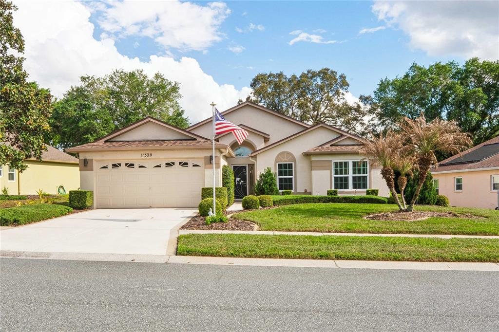 a front view of a house with a yard and garage