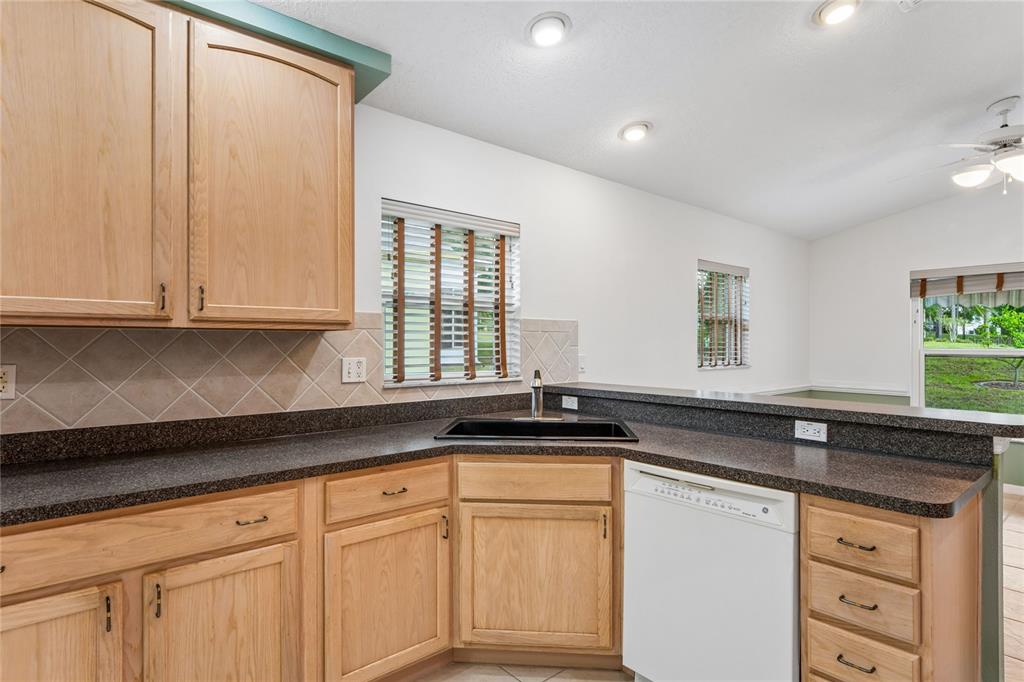 11330 Leeds Drive Spring Hill, FL 34609 - Photo 11 of 78 a kitchen with granite countertop white cabinets and a sink