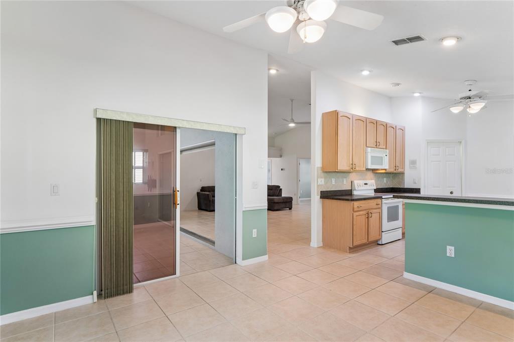 11330 Leeds Drive Spring Hill, FL 34609 - Photo 16 of 78 a large kitchen with a refrigerator a stove top oven and a sink