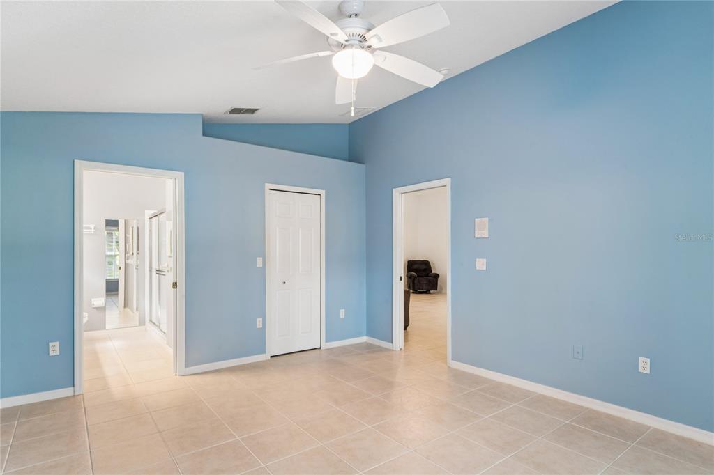 11330 Leeds Drive Spring Hill, FL 34609 - Photo 19 of 78 an empty room with closet and a chandelier fan