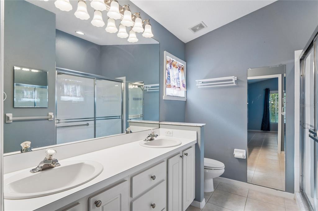 11330 Leeds Drive Spring Hill, FL 34609 - Photo 21 of 78 a bathroom with a sink vanity and a mirror
