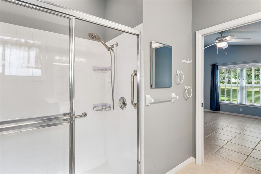 11330 Leeds Drive Spring Hill, FL 34609 - Photo 23 of 78 a bathroom with a glass shower door and a shower